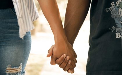 The YDF videos address themes of STI testing, pornography, stigma, shame and consent. a close up of the hands of two people holding hands